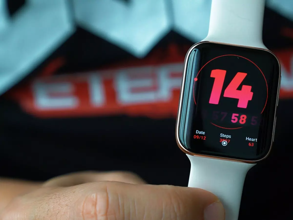 A smartwatch on a wrist, closeup of the display with a red number 14